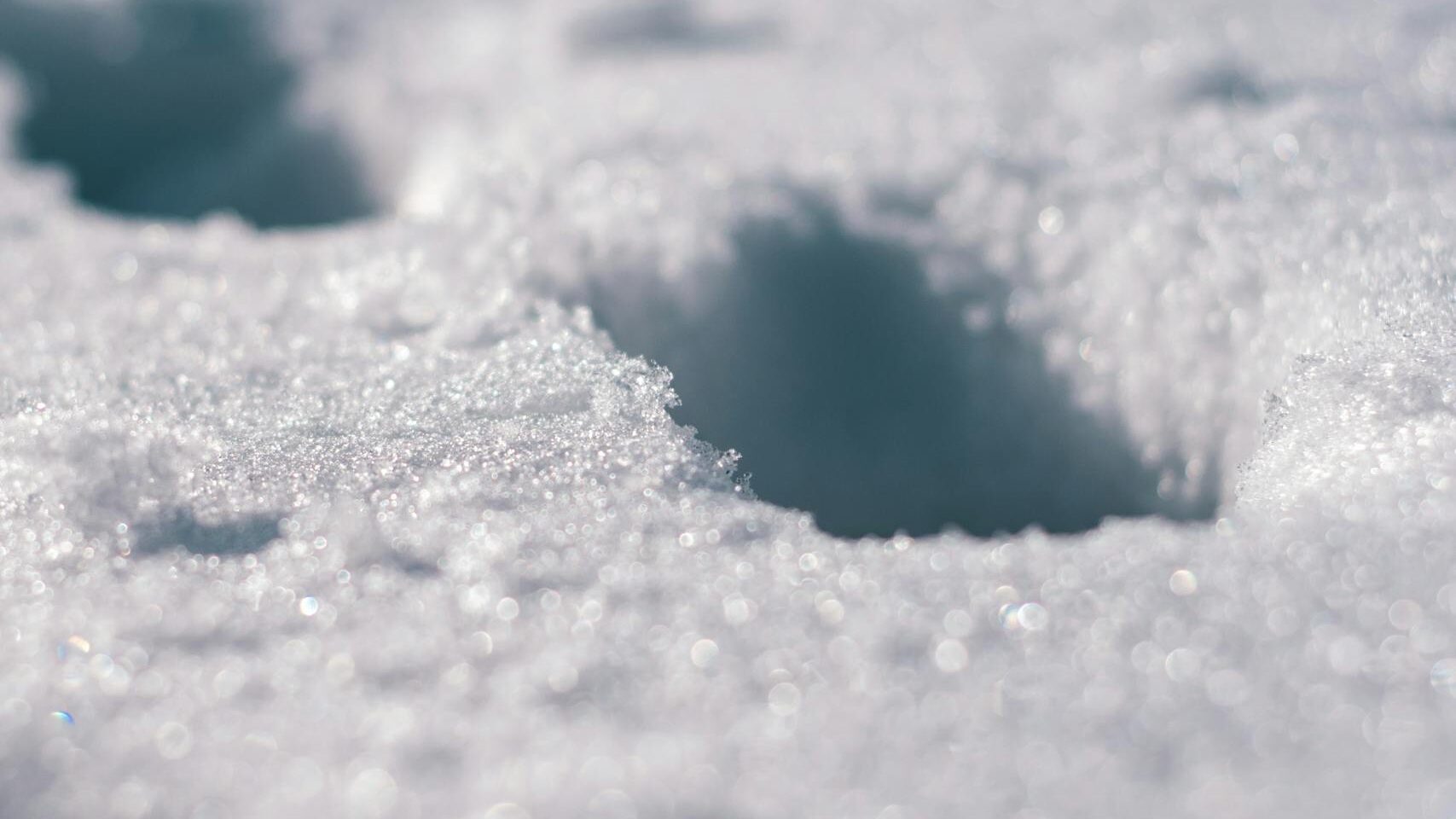 close up of footprints in sparkling snow capturing a cold winter atmosphere. 1693431 scaled e1734113117694