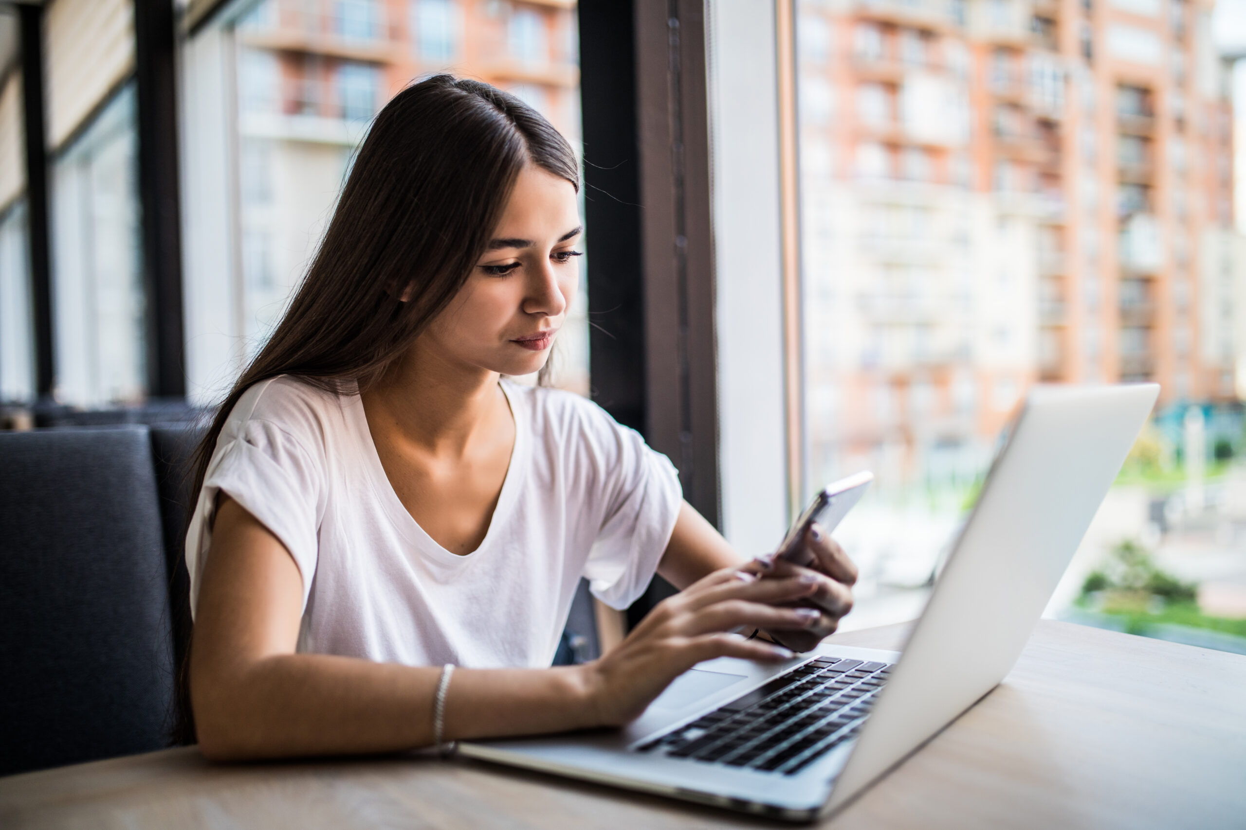 CASE STUDY: Modernizing Customer Data & Marketing Activation for a Global Life Sciences Leader 3 young girl with cell phone laptop cup coffee scaled